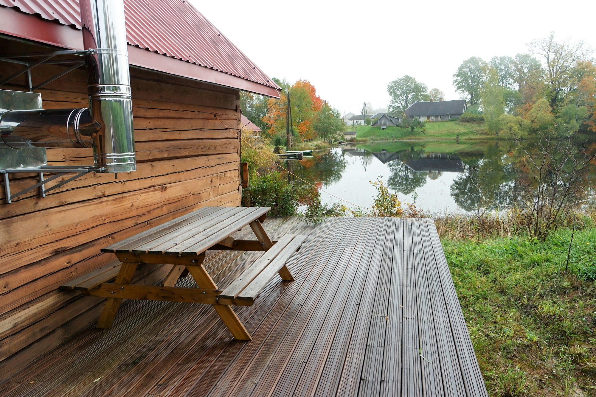 Wooden cottage near the lake in the woods.